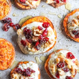 Sweet Potato Rounds with Herbed Ricotta Roasted Walnuts, Cranberries, and Honey on a baking sheet, ready to serve