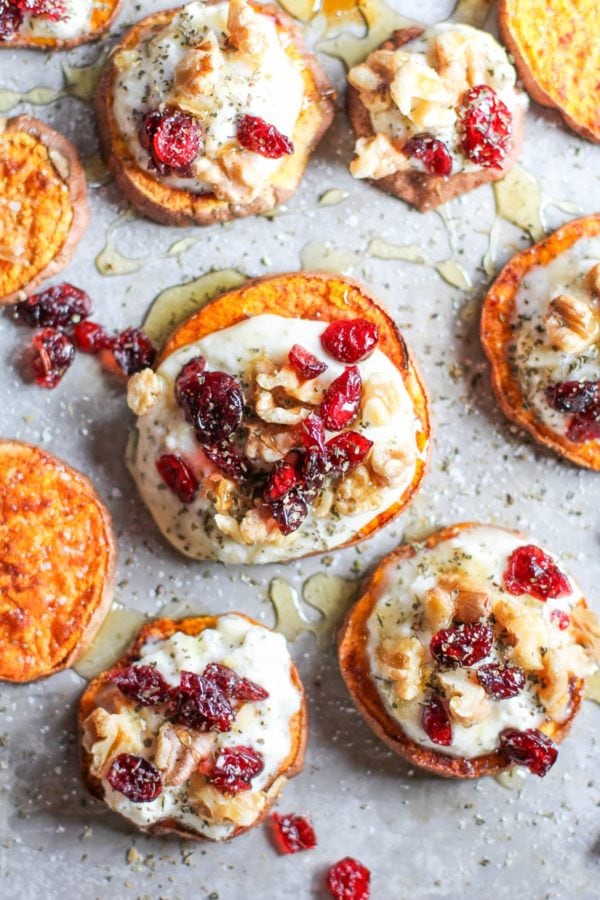 Sweet Potato Rounds with Herbed Ricotta Roasted Walnuts, Cranberries, and Honey on a baking sheet, ready to serve