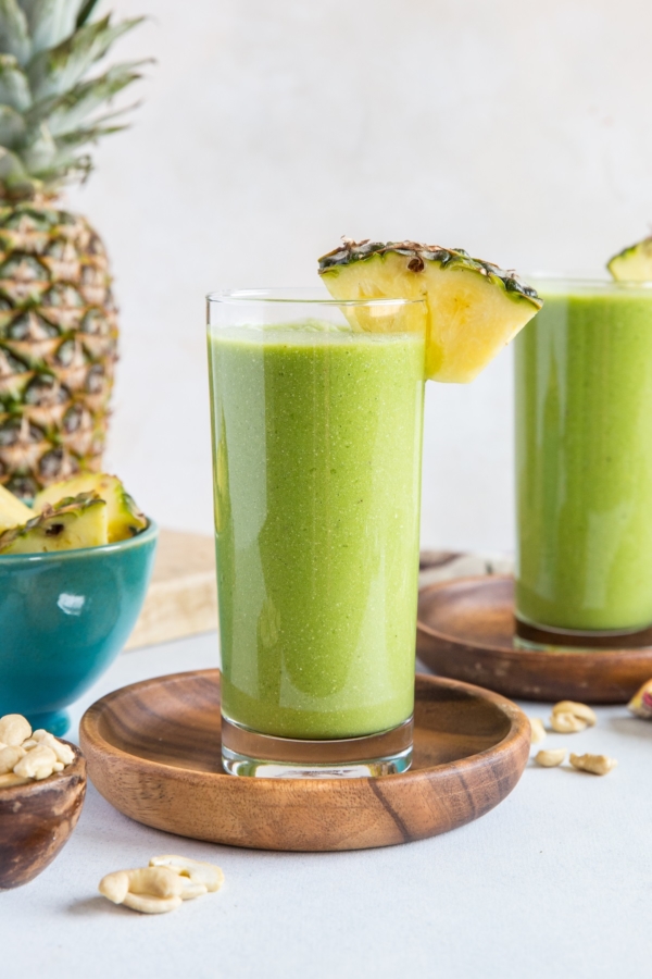 Two glasses of pineapple green protein smoothie