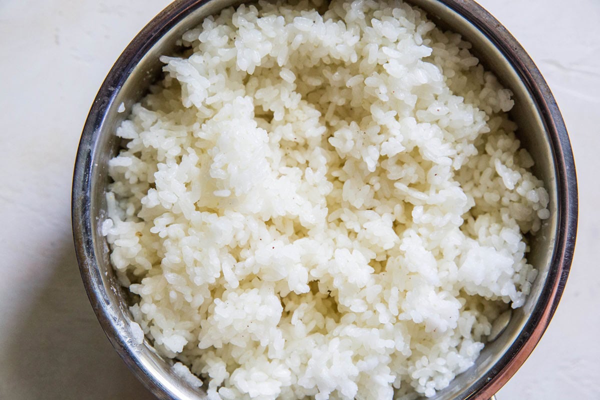 Saucepan full of cooked sushi rice to make tuna and rice casserole.