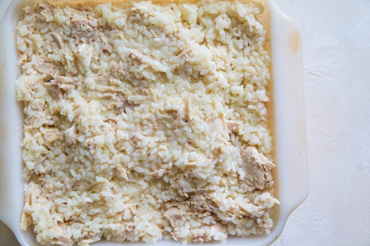 Casserole dish with tuna and rice mixture inside, ready to go into the oven to make casserole.