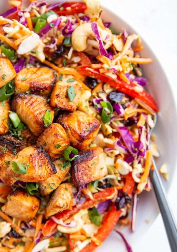 Crispy salmon chunks on top of a salad to make a full meal.