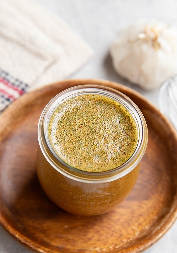 Soy garlic marinade in a small jar, ready to be used on chicken.