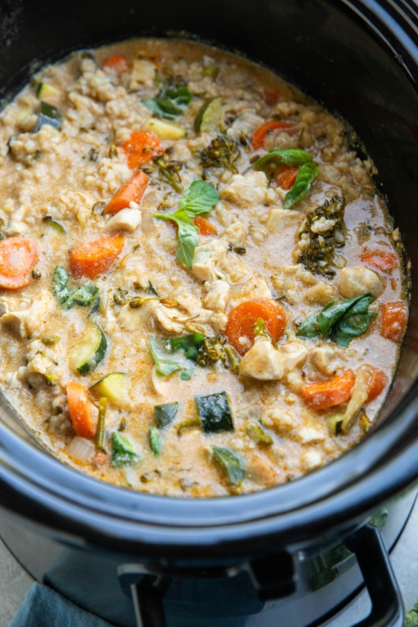 Slow cooker full of chicken curry with vegetables.