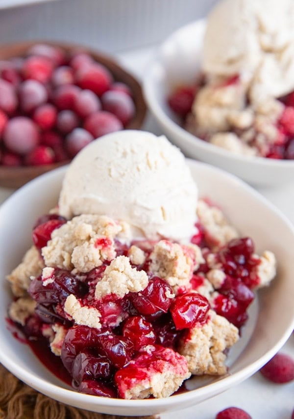 Two white bowls of cranberry crumble