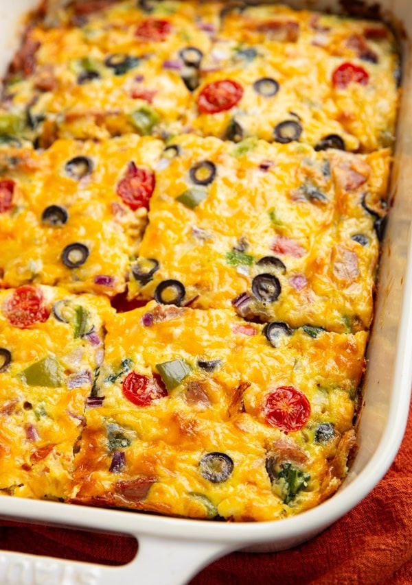 Casserole dish of sausage breakfast casserole cut into slices.