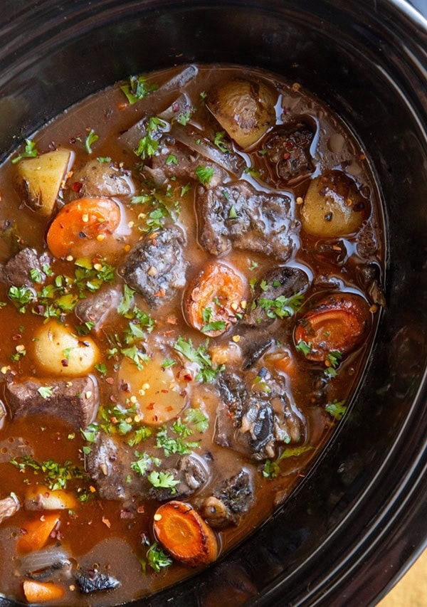 slow cooker beef bourguignon in a crock pot, ready to eat.