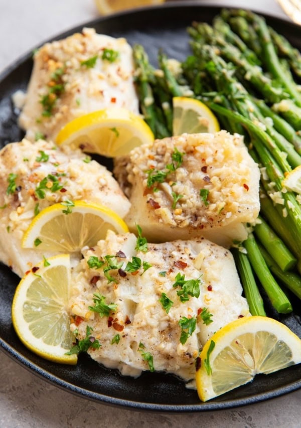 Garlic butter cod on a plate, ready to serve.