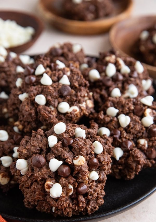 Pile of double chocolate cookies on a black plate.