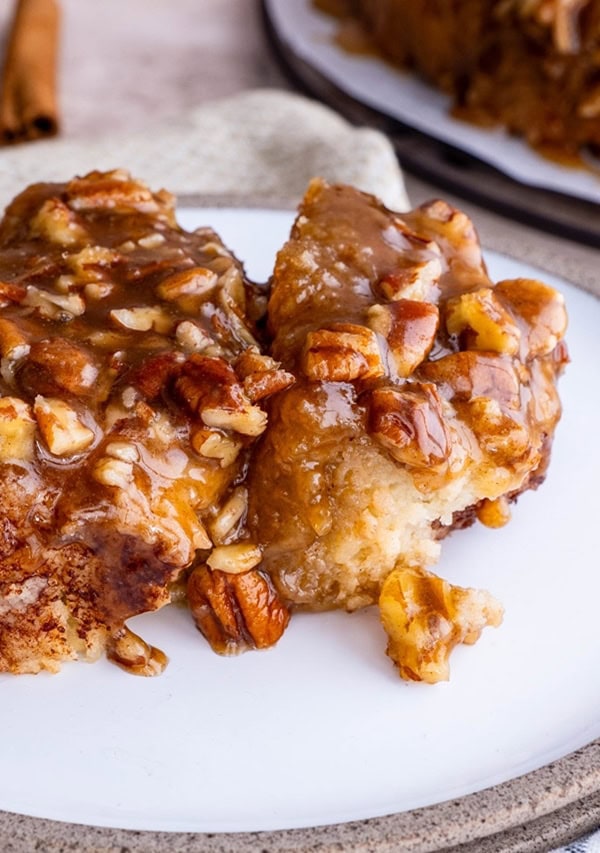 Caramel pecan sticky bun on a plate, ready to serve.