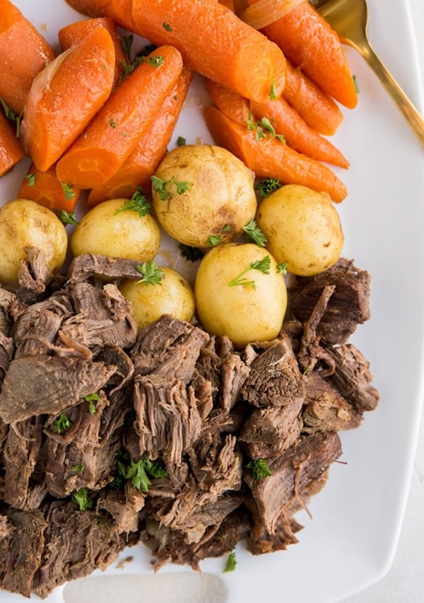 Shredded beef, potatoes, and carrots on a serving platter