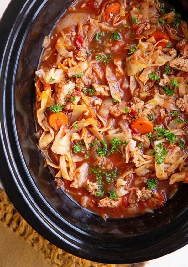 Crock pot full of sausage and cabbage soup