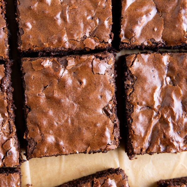 Gluten-free brownies with shiny crackle top, cut into slices.
