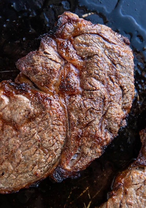 Broiled steak on a baking sheet.