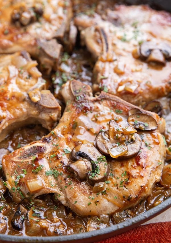 Pork chops in a skillet smothered in gravy