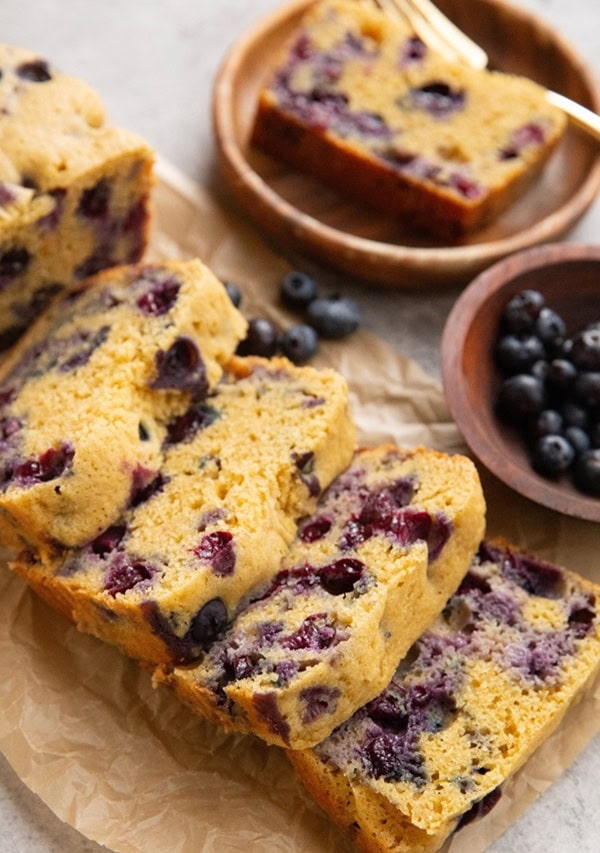 Loaf of blueberry bread cut into slices.