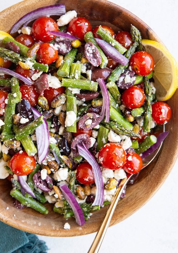 Wooden bowl of asparagus salad.