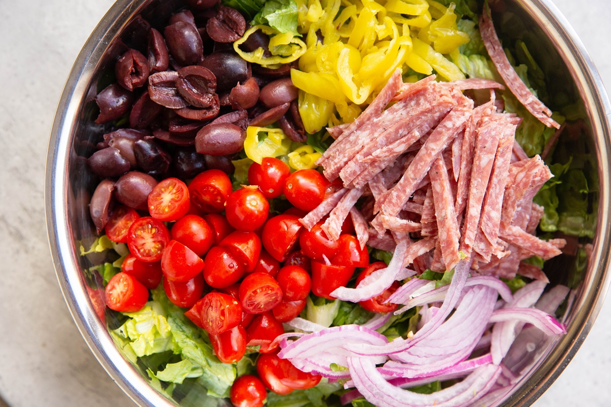 Ingredients for Italian chopped salad in a large bowl.