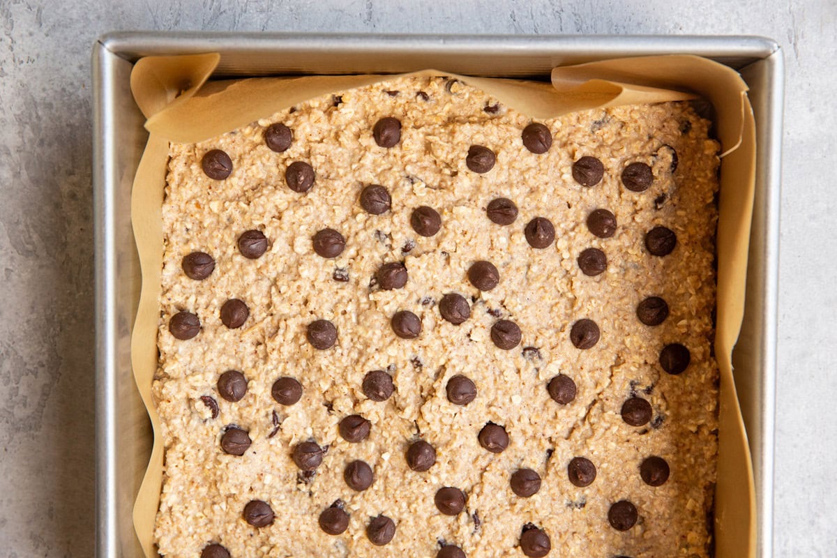 Baking pan of applesauce bar batter with chocolate chips on top, ready to go into the oven.