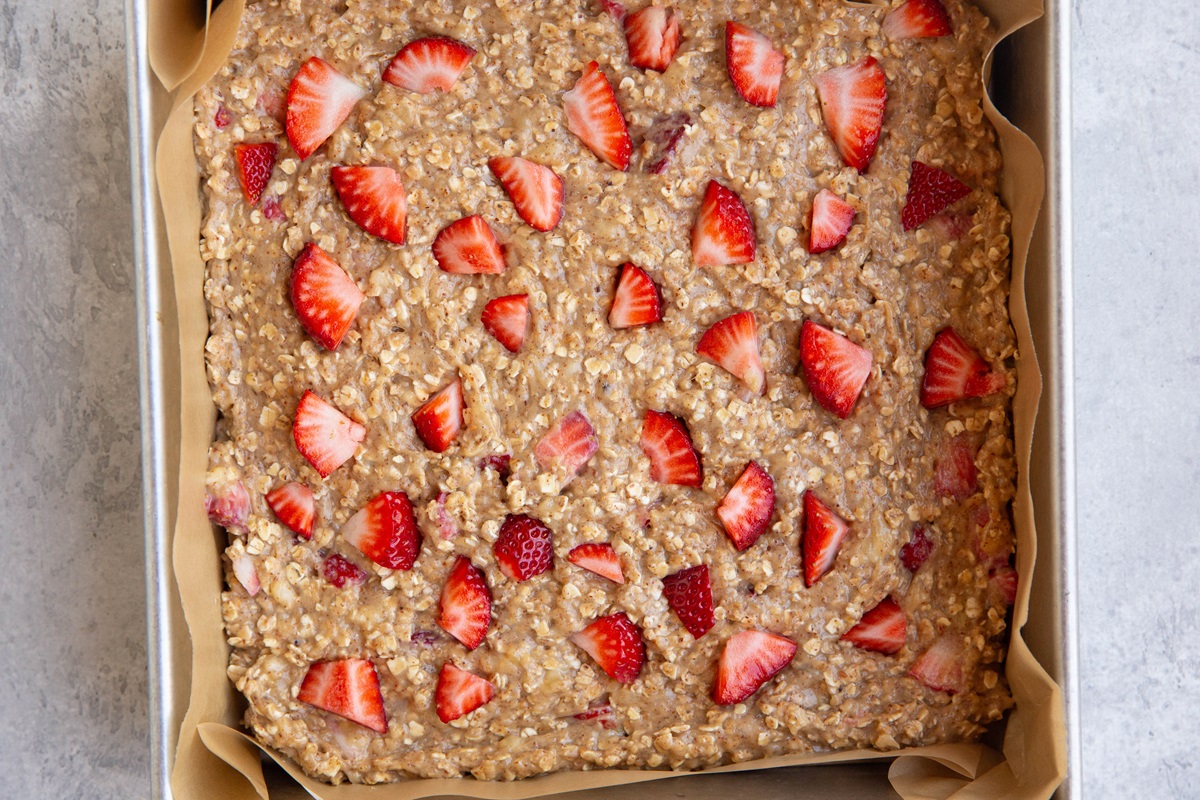Strawberry oatmeal mixture spread in an even layer in a baking dish.