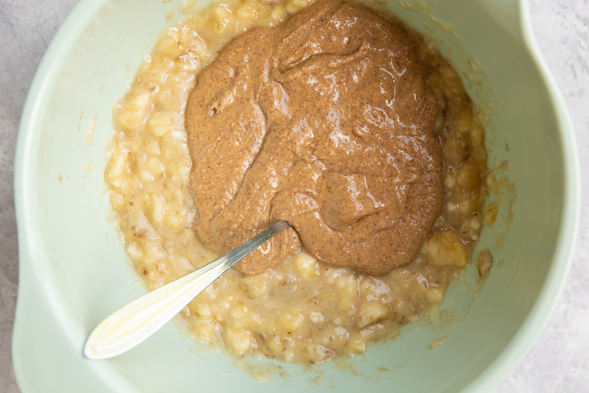 Mashed banana and almond butter in a mixing bowl.