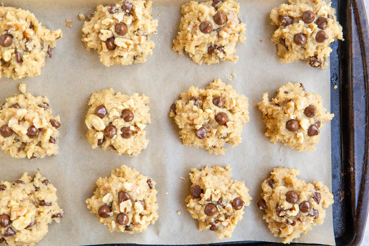 Mounds of cookie dough on a baking sheet.