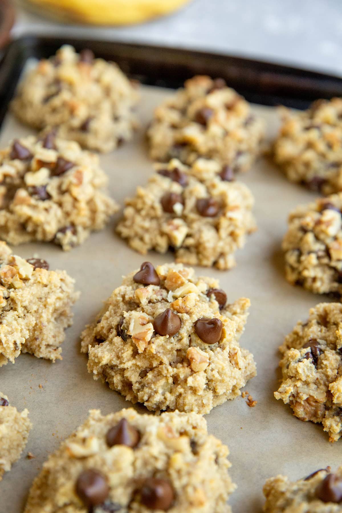 Batch of almond flour banana cookies on a baking sheet.