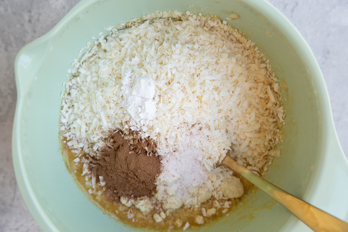 Almond flour, shredded coconut, cinnamon, and sea salt in a mixing bowl.
