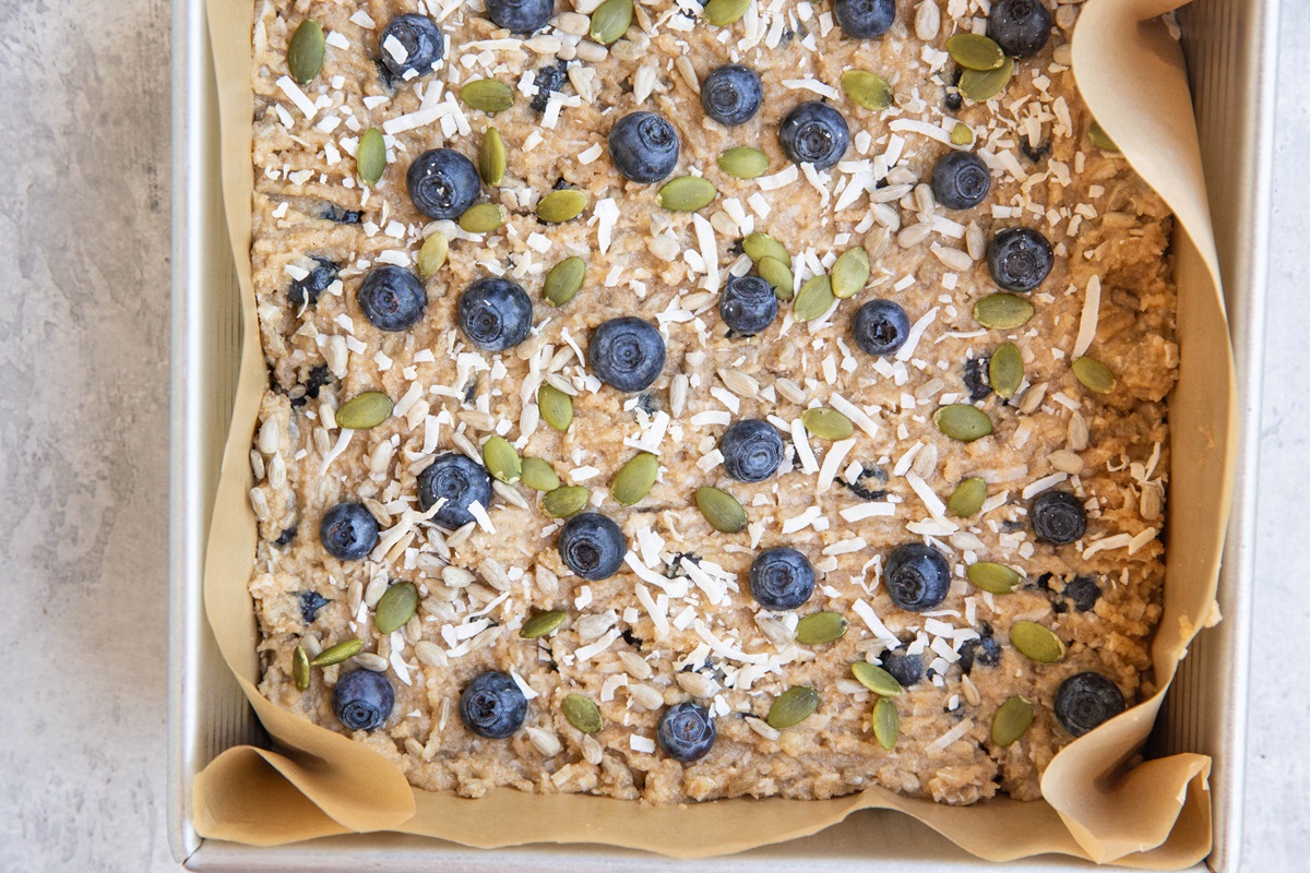 Baking dish with breakfast bar mixture spread in an even layer, ready to go into the oven.