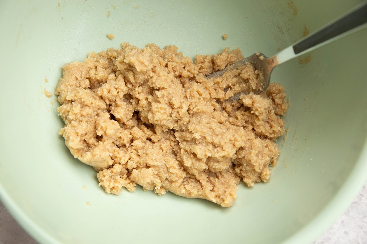 Almond flour crumble mixture in a mixing bowl.