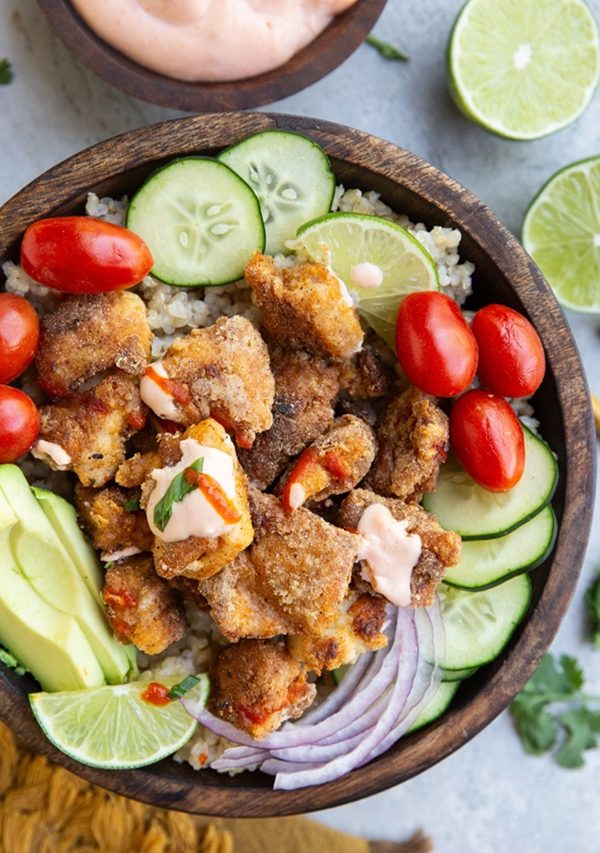Wooden bowl of crispy chicken with vegetables