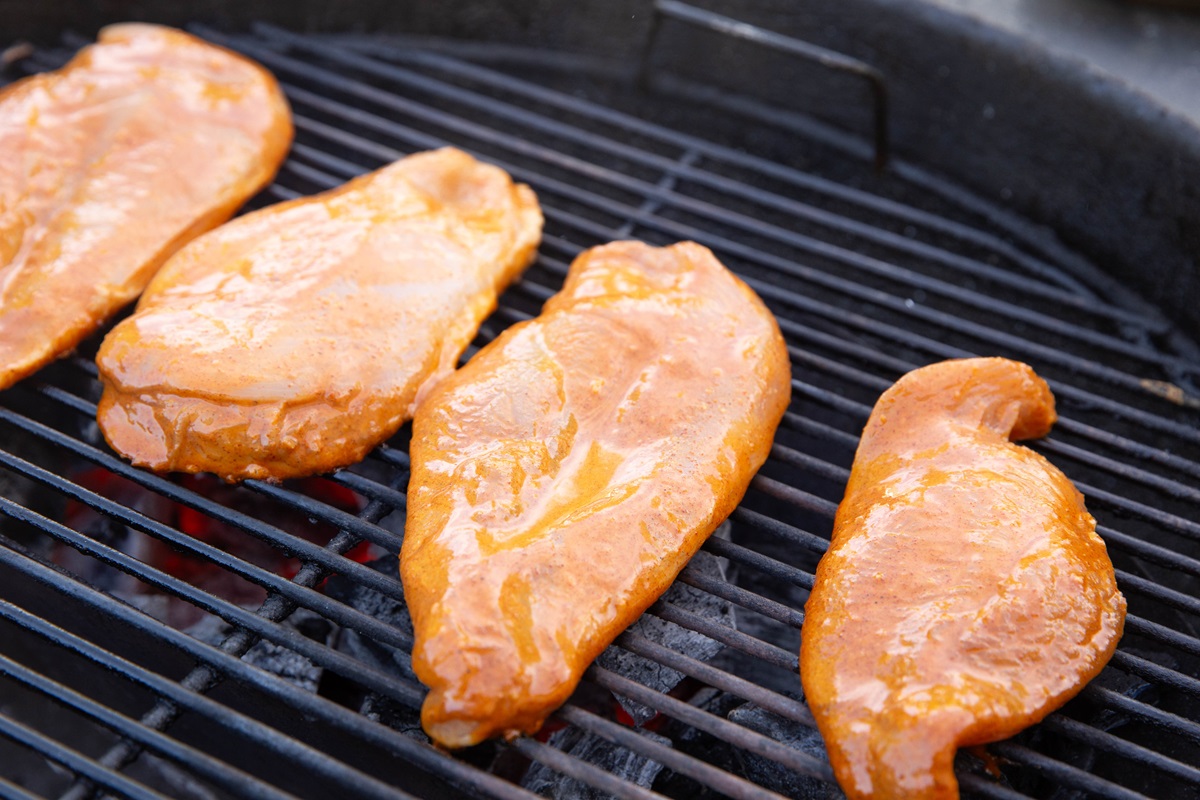 Marinated chicken on a grill.