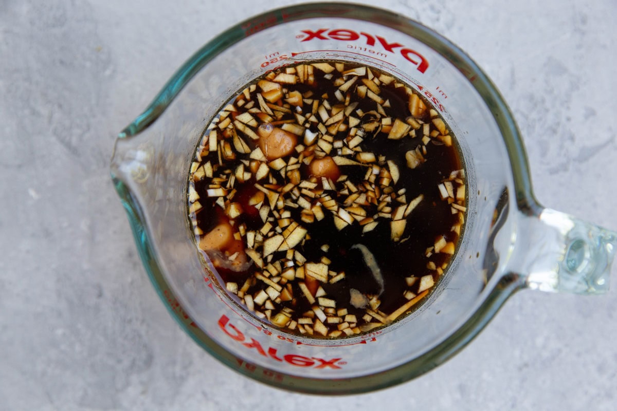 Ingredients for peanut dressing in a measuring cup.