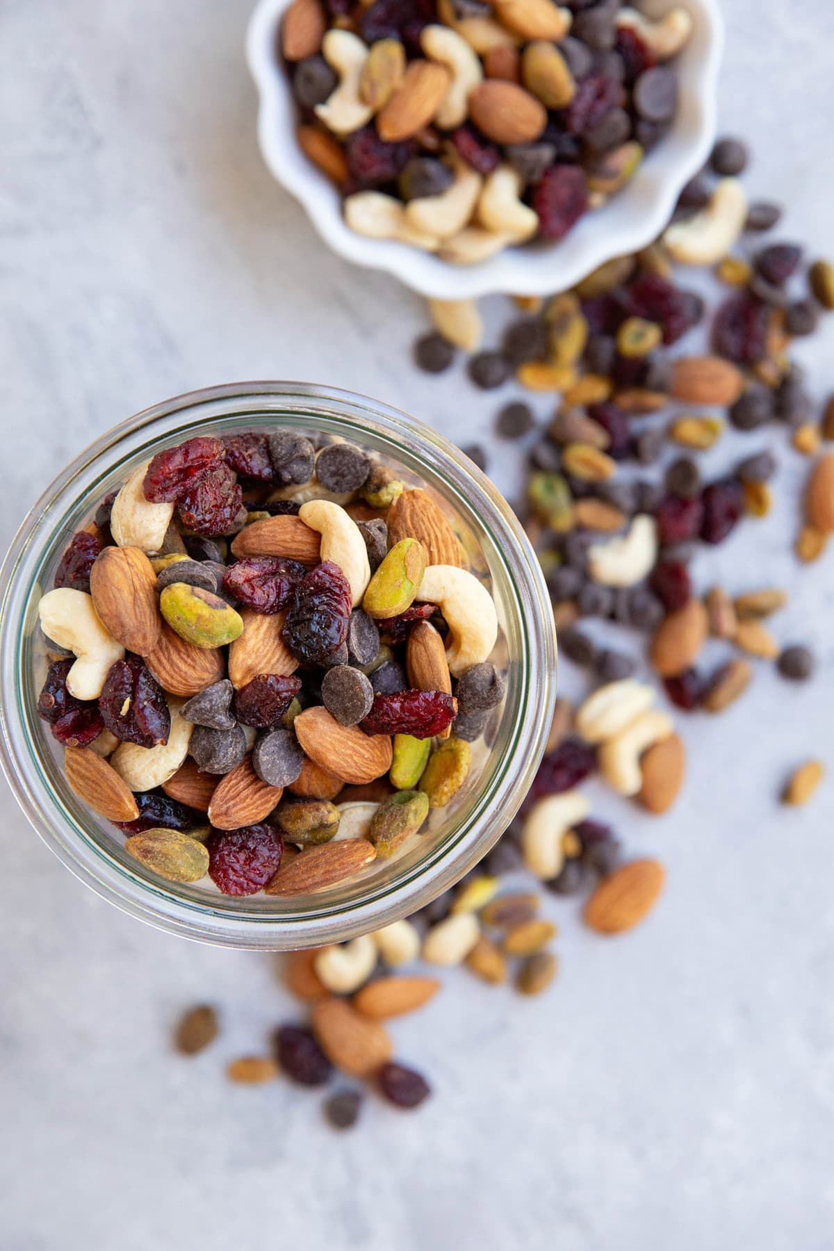 Trail mix in a glass jar and a bowl of trail mix.