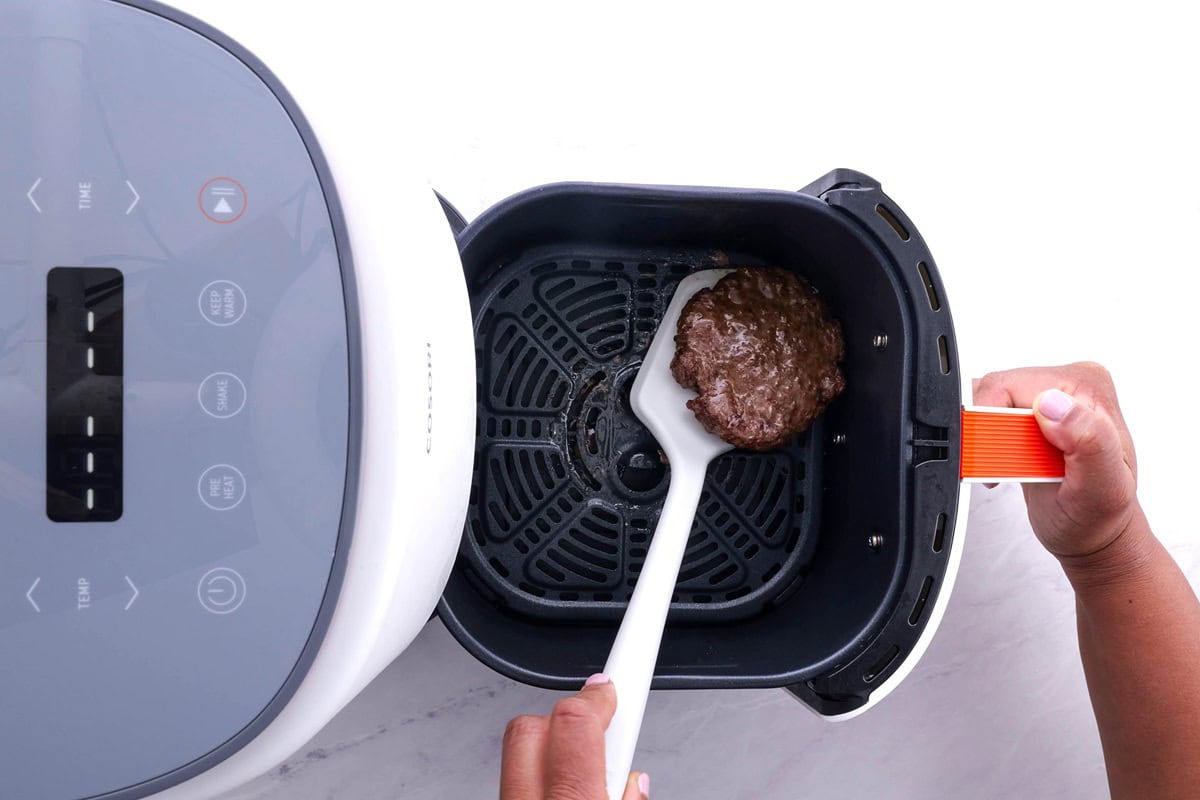 Flipping the air fryer patty to the other side.