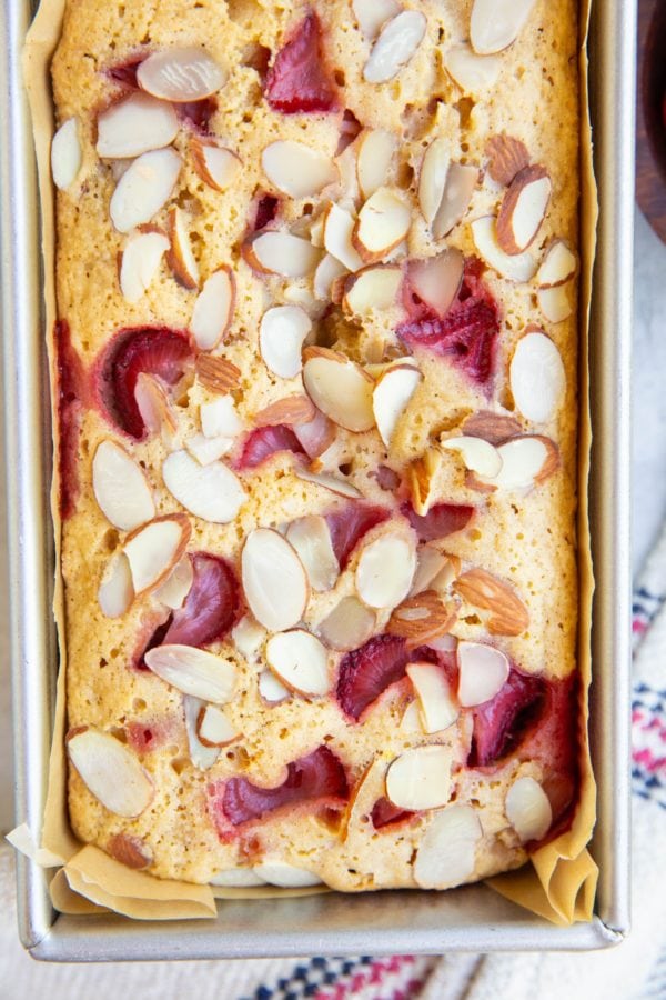 Loaf pan with almond flour strawberry bread inside, fresh out of the oven.