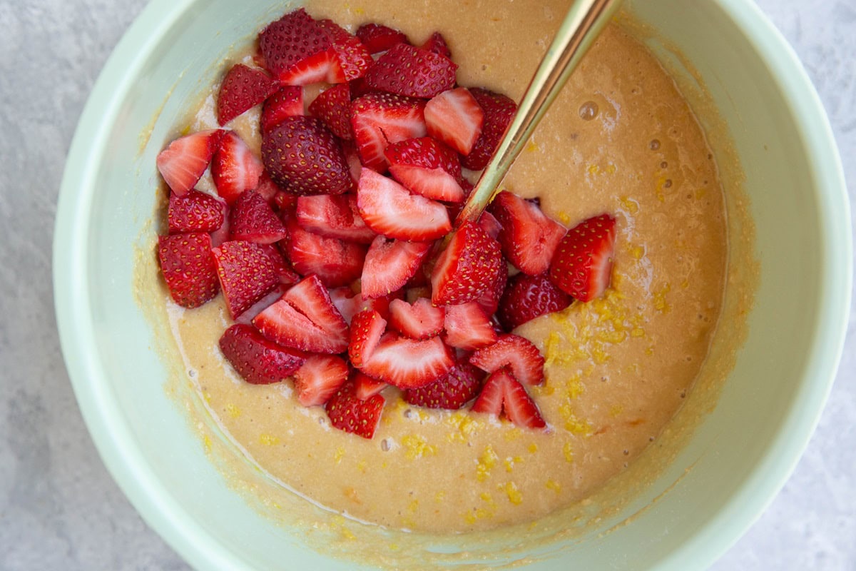 Almond flour strawberry bread batter with fresh strawberries on top.