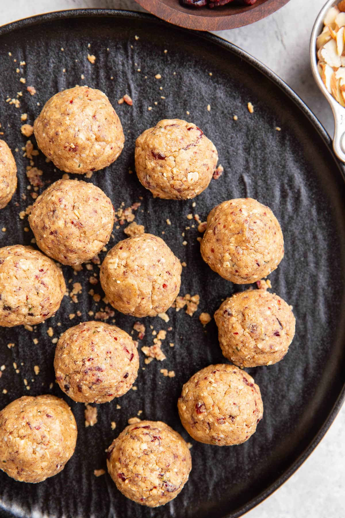 Protein balls on a black plate, ready to be eaten.