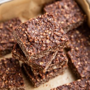 Stack of no-bake cookie bars in a baking dish, ready to eat.