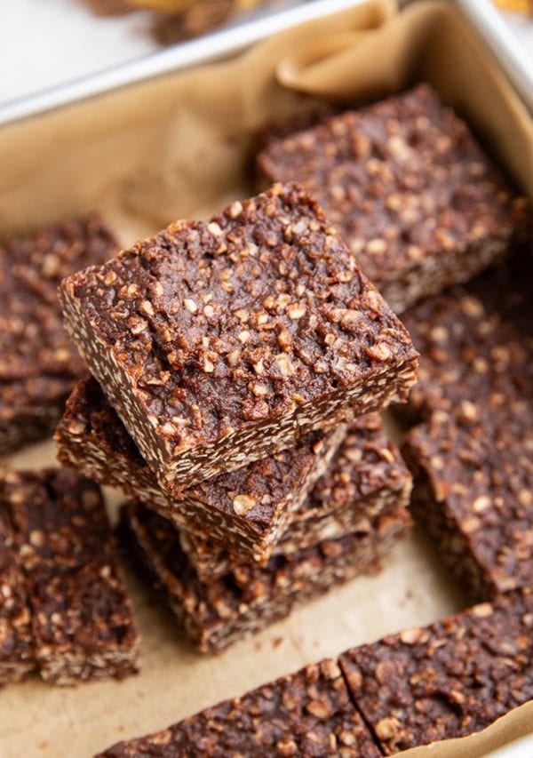 Stack of no-bake cookie bars in a baking dish, ready to eat.