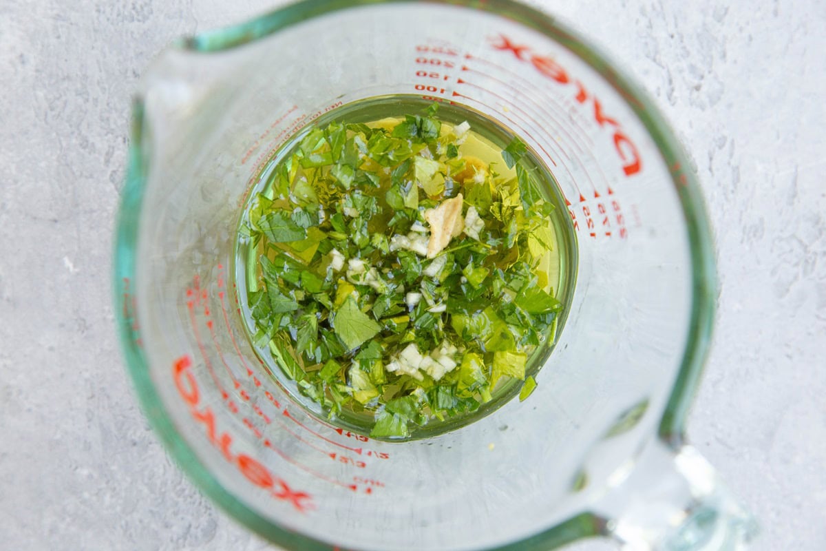 Salad dressing ingredients in a measuring cup, ready to be stirred.