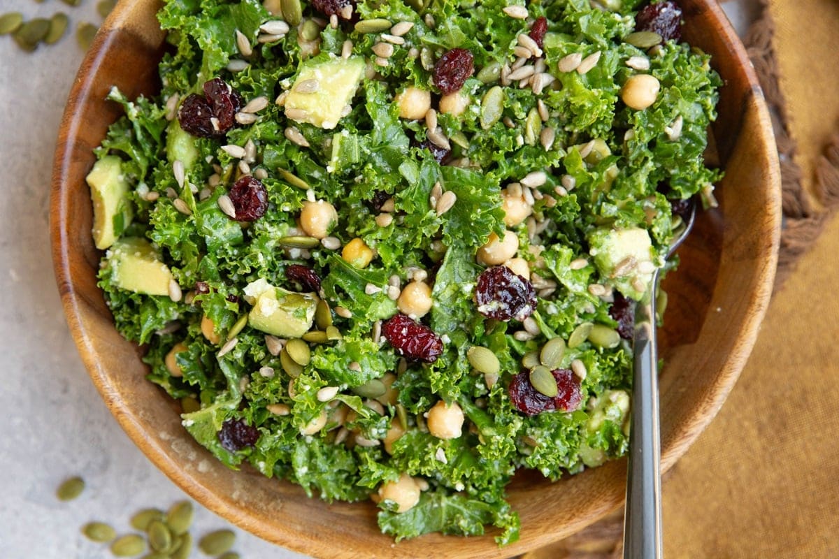 Big bowl of kale salad with a fork, ready to eat.