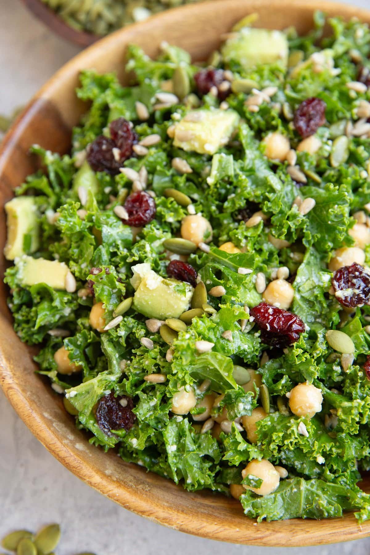 Big wood bowl of kale salad, ready to serve.