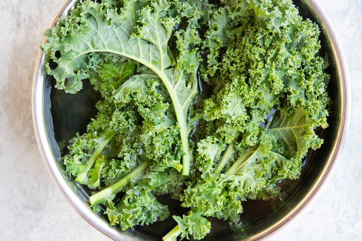 Kale leaves soaking in a large bowl to get any bugs off.