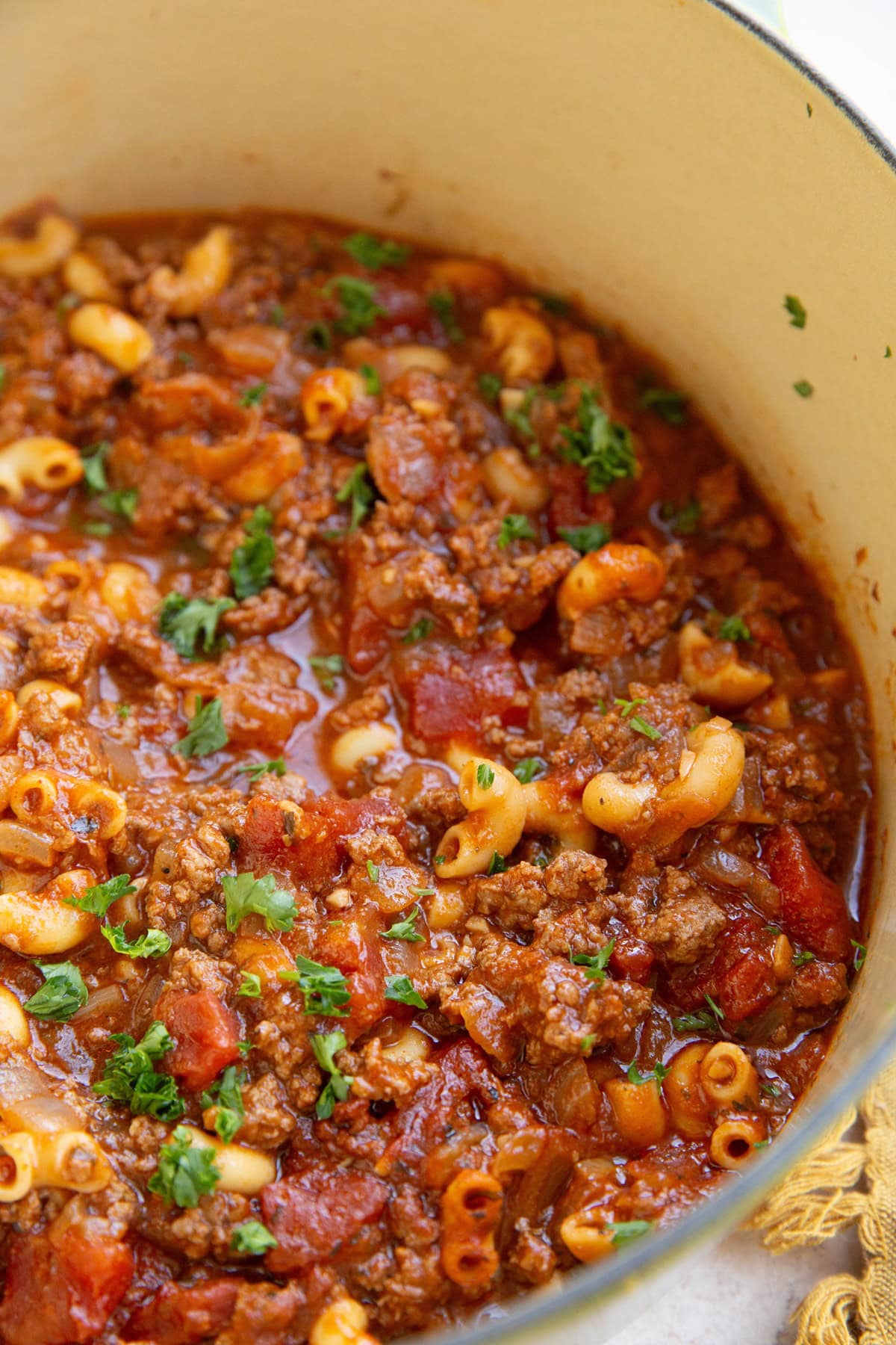 Pot of American beef goulash with ground beef and noodles and tomato sauce.