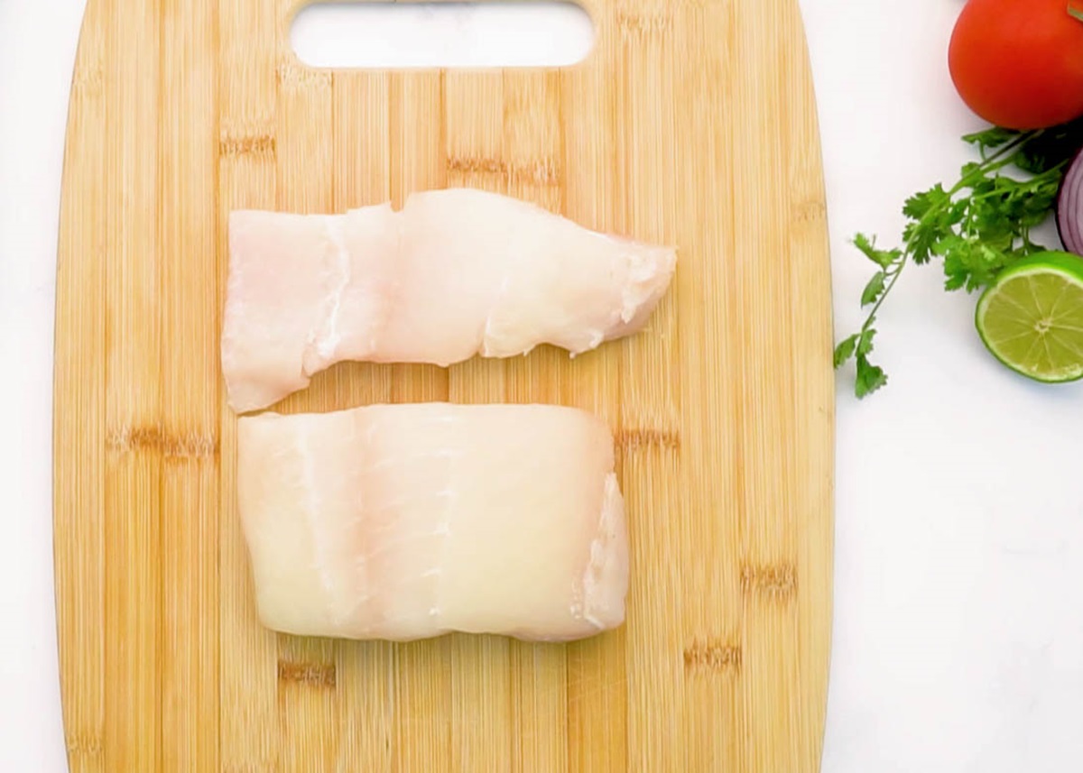 Two halibut filets on a cutting board to make fish ceviche.