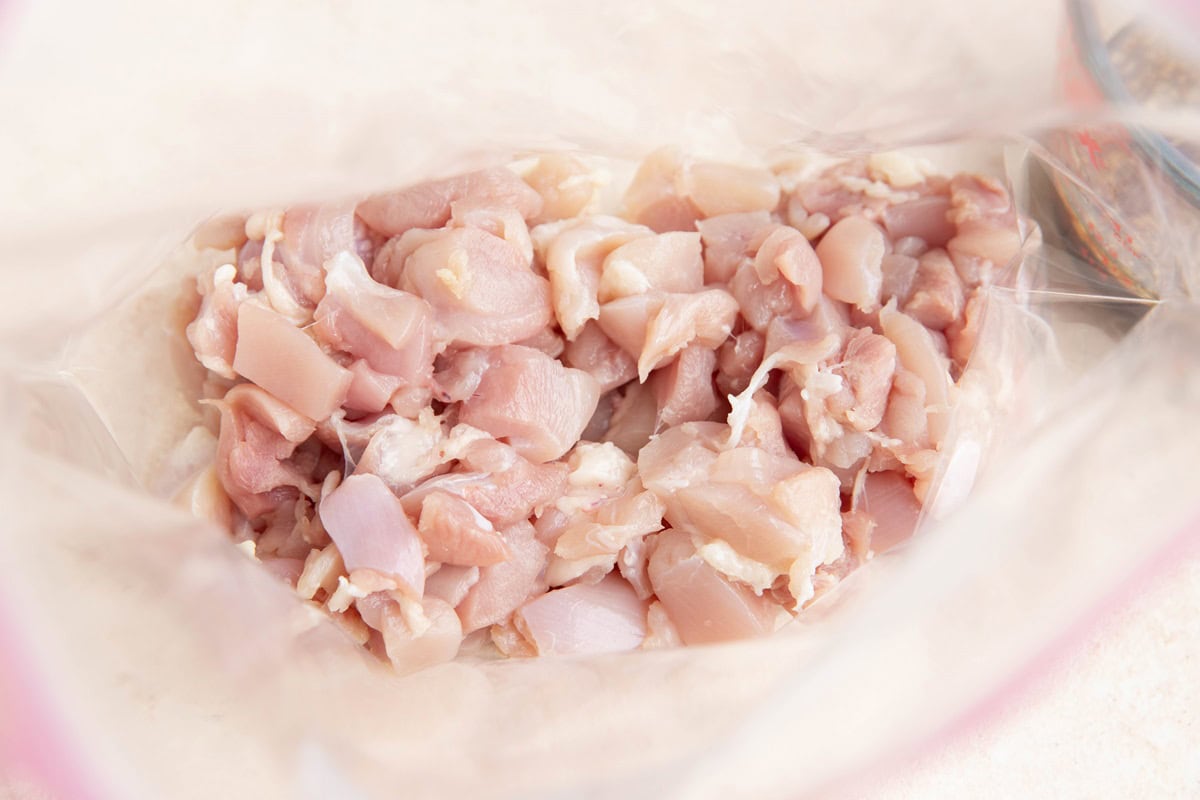 Chopped chicken thighs in a zip lock bag.