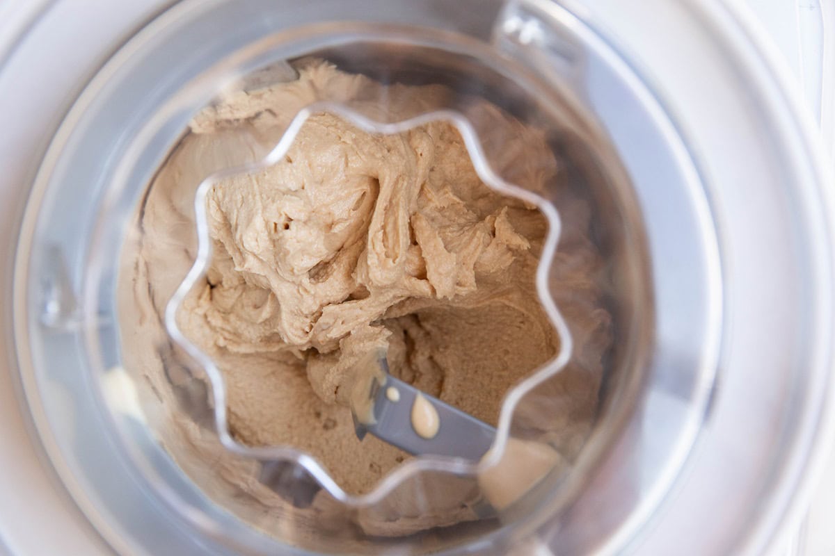 Ice cream machine with peanut butter frozen yogurt churning inside.