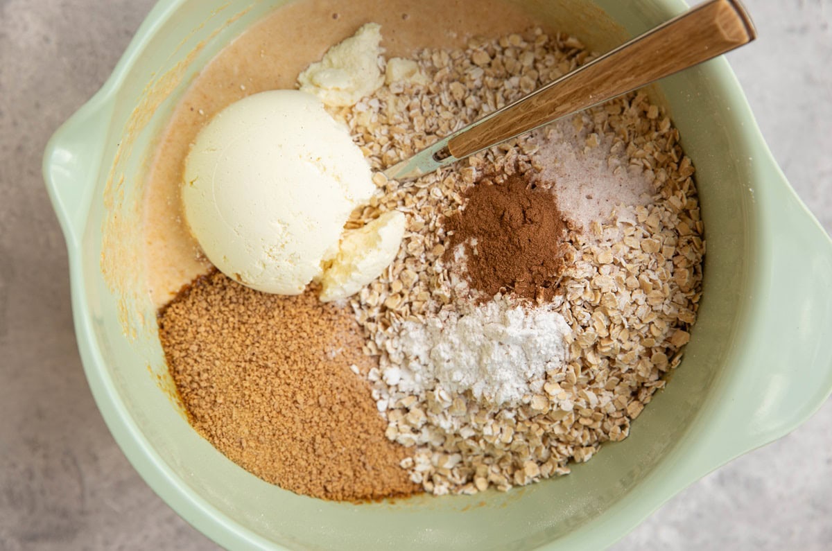 Mixing bowl with dry ingredients on top of wet ingredients to make protein cookies.