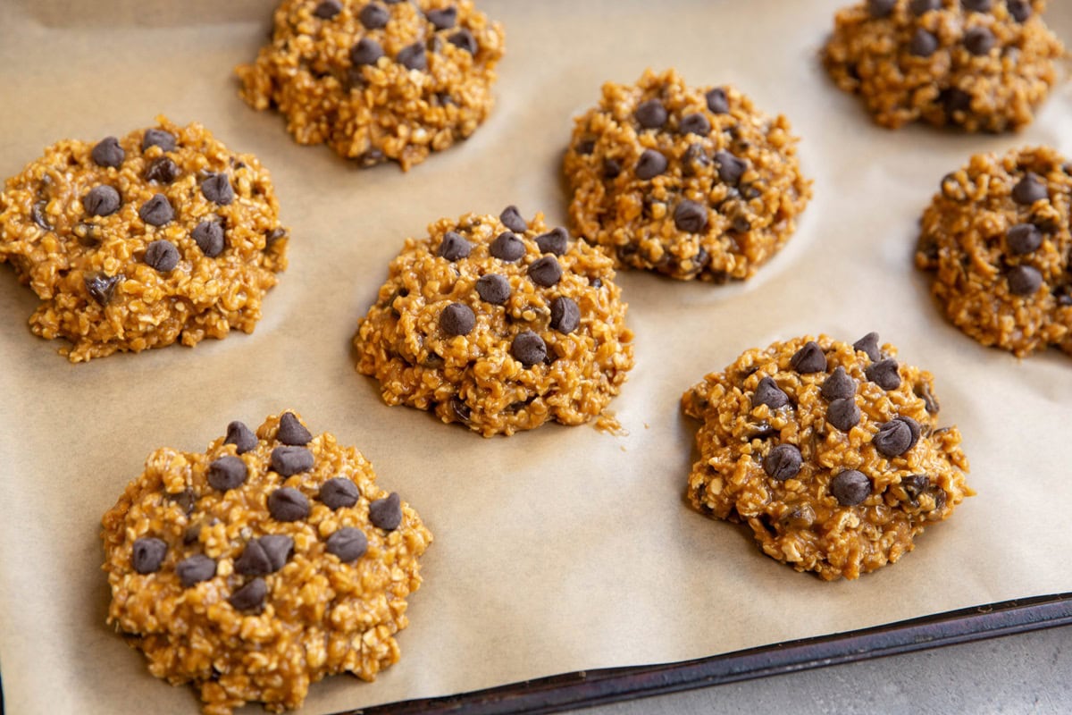 Baking sheet with mounds of cookie dough, ready to go into the oven.